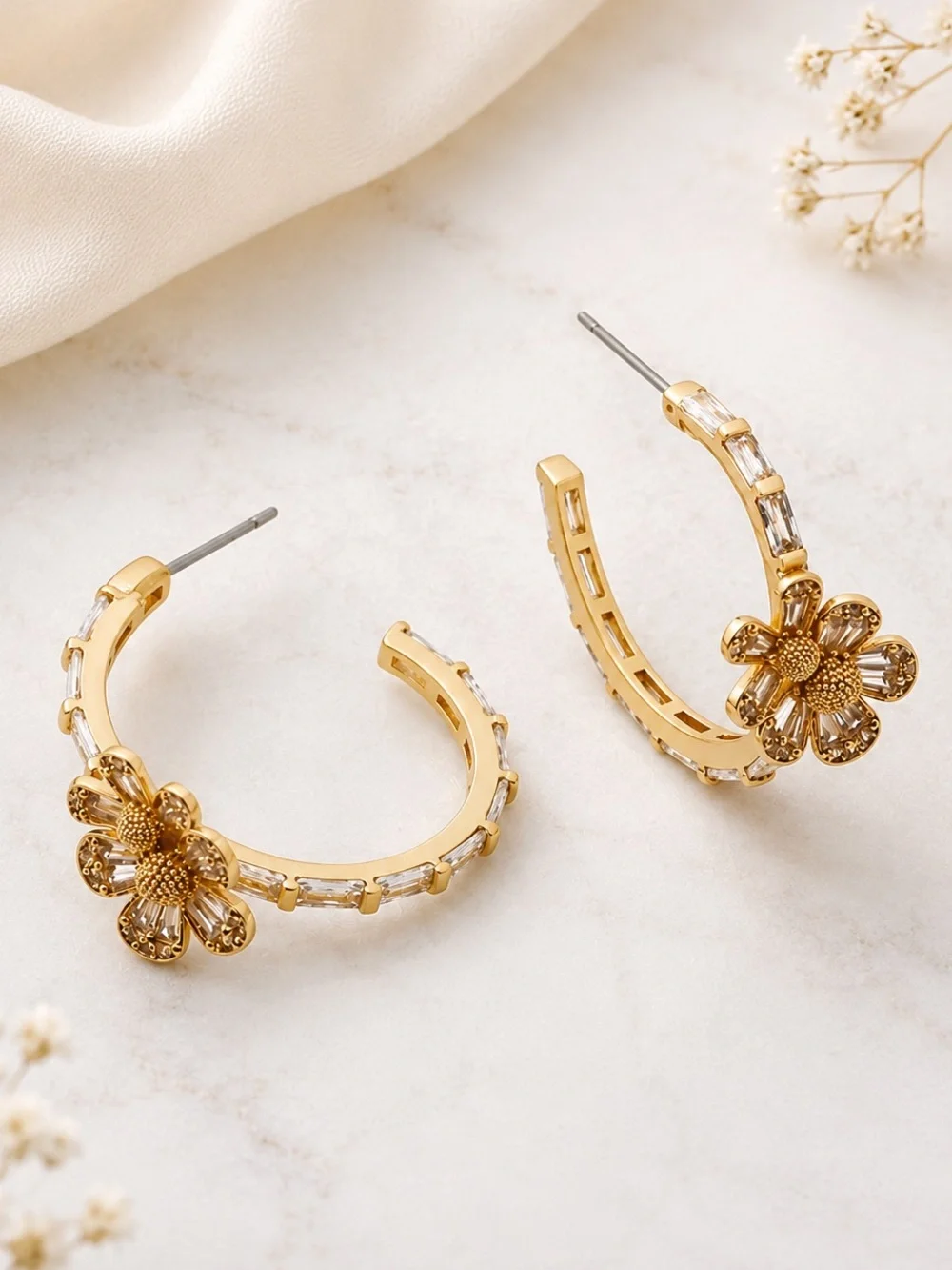Kate Spade Fleurette Hoops in gold.